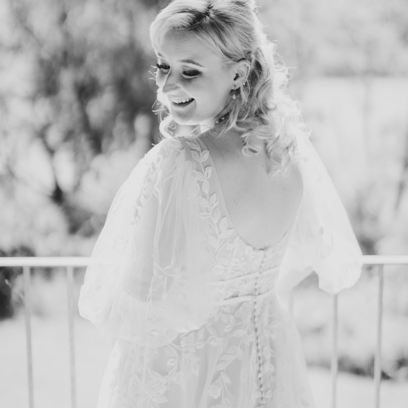 Bride on a balcony looking over her shoulder