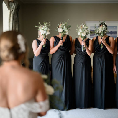 Bridesmaids hiding faces behind bouquets