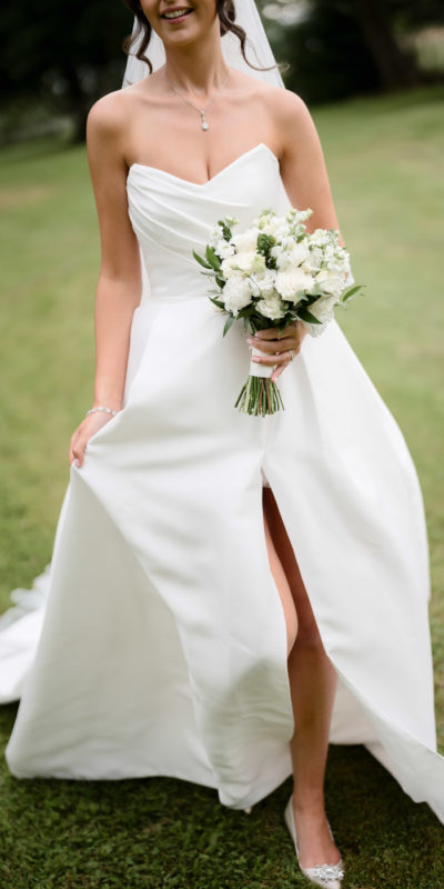 Close-up shot of bride holding her bouquet outside