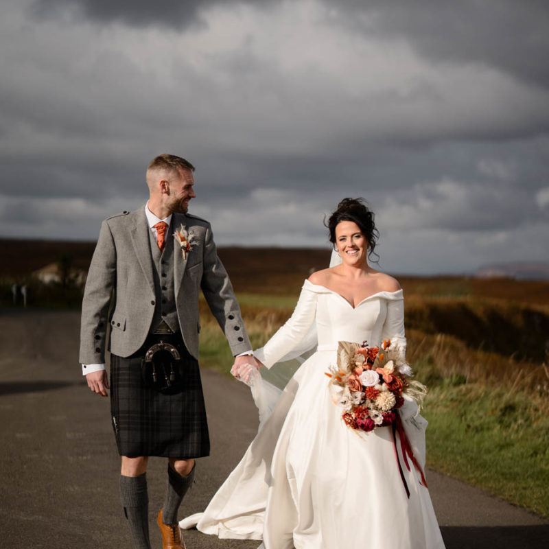 Happy bride and groom in beautiful sunlight at Dunnet Head