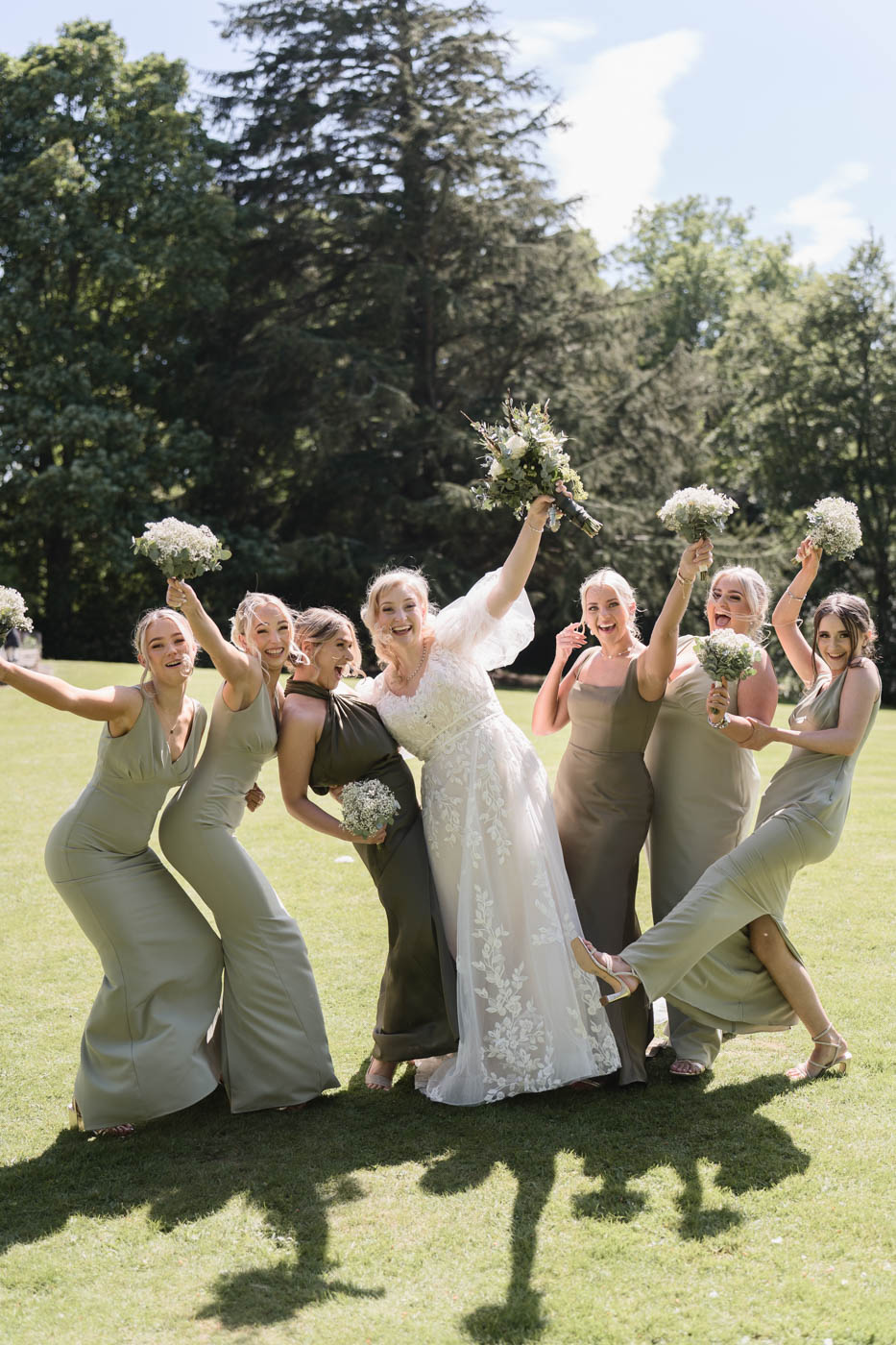 Bride and bridesmaids waving and laughing