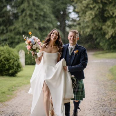 Happy couple in the rain for their scottish highland wedding