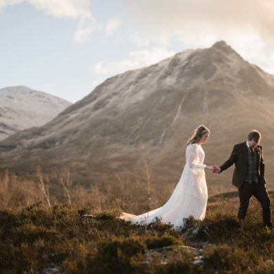 Bride and groom wandering through Glen Etive during their elopment