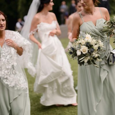 Bridesmaids with bouquets and handbags at a Highland wedding