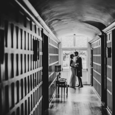 Couple kissing at the end of a corridor with leading lines