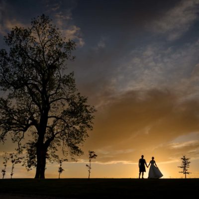 Silhouette of a bride and groom at sunset