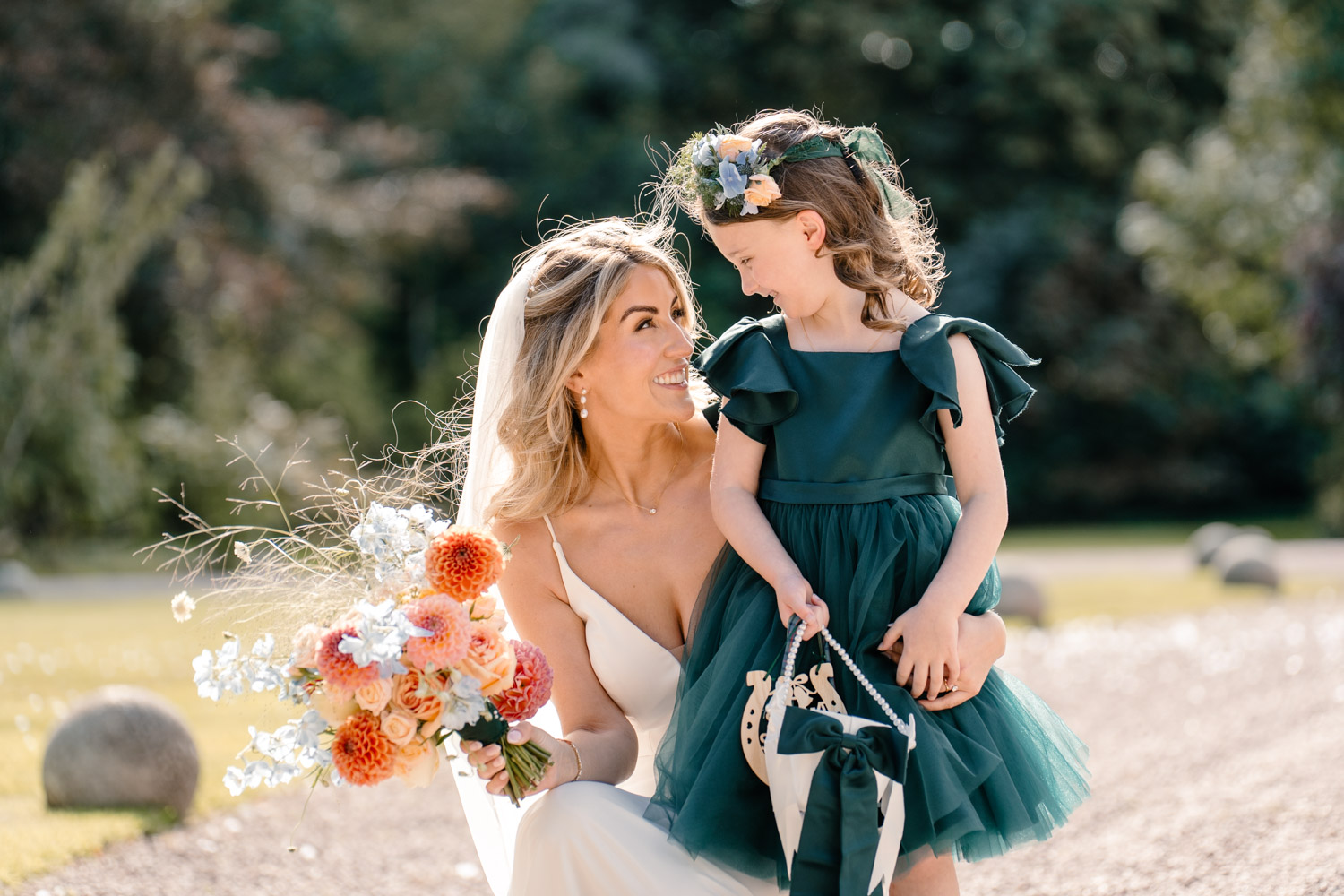 Tender moment between bride and flower gir