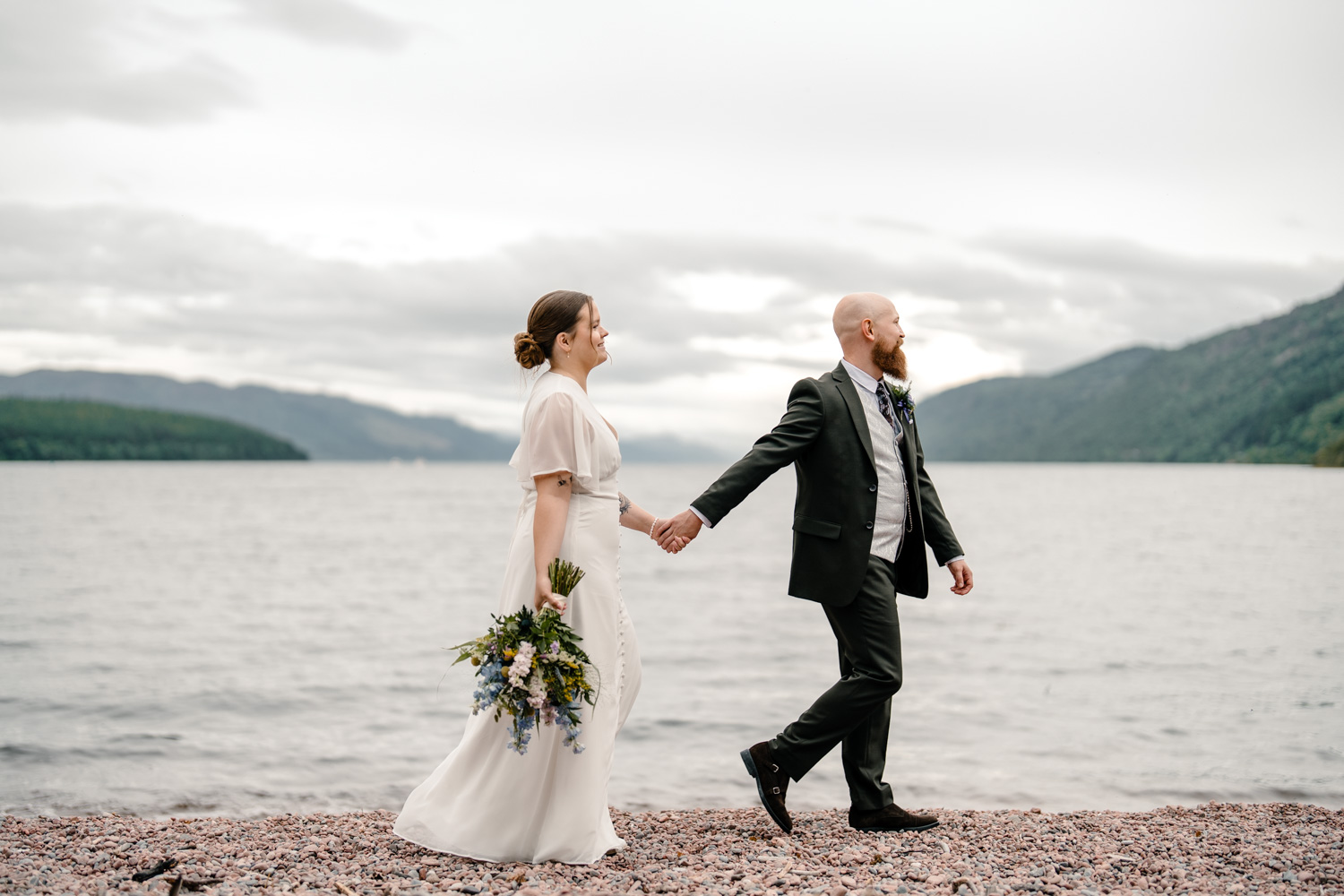Bride and groom strolling through scenic surroundings