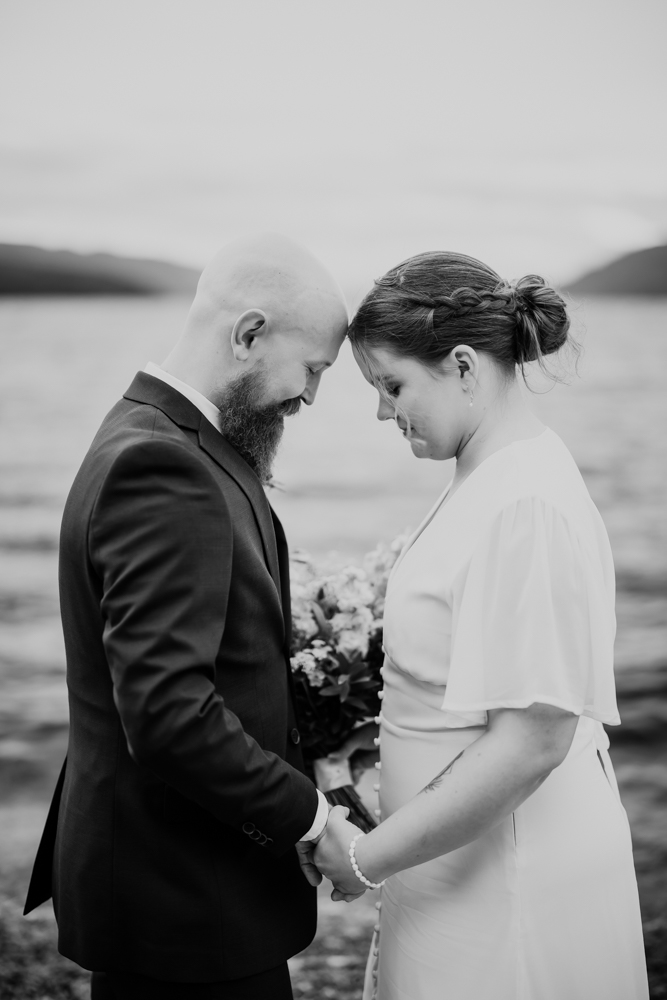 Black and white image of a couple sharing a quiet moment on the shores of Loch Ness