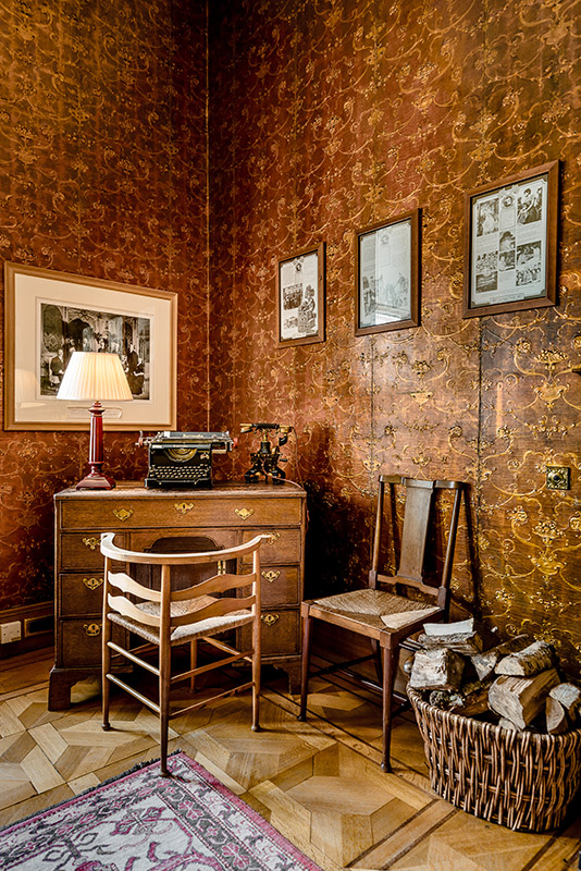 Vintage wooden desk chair and classic rotary telephone in interior setting