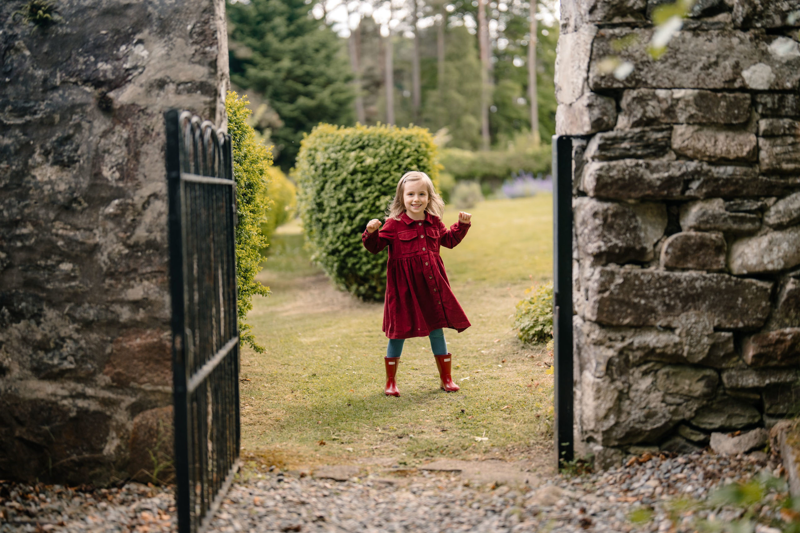 Child standing in walled garden