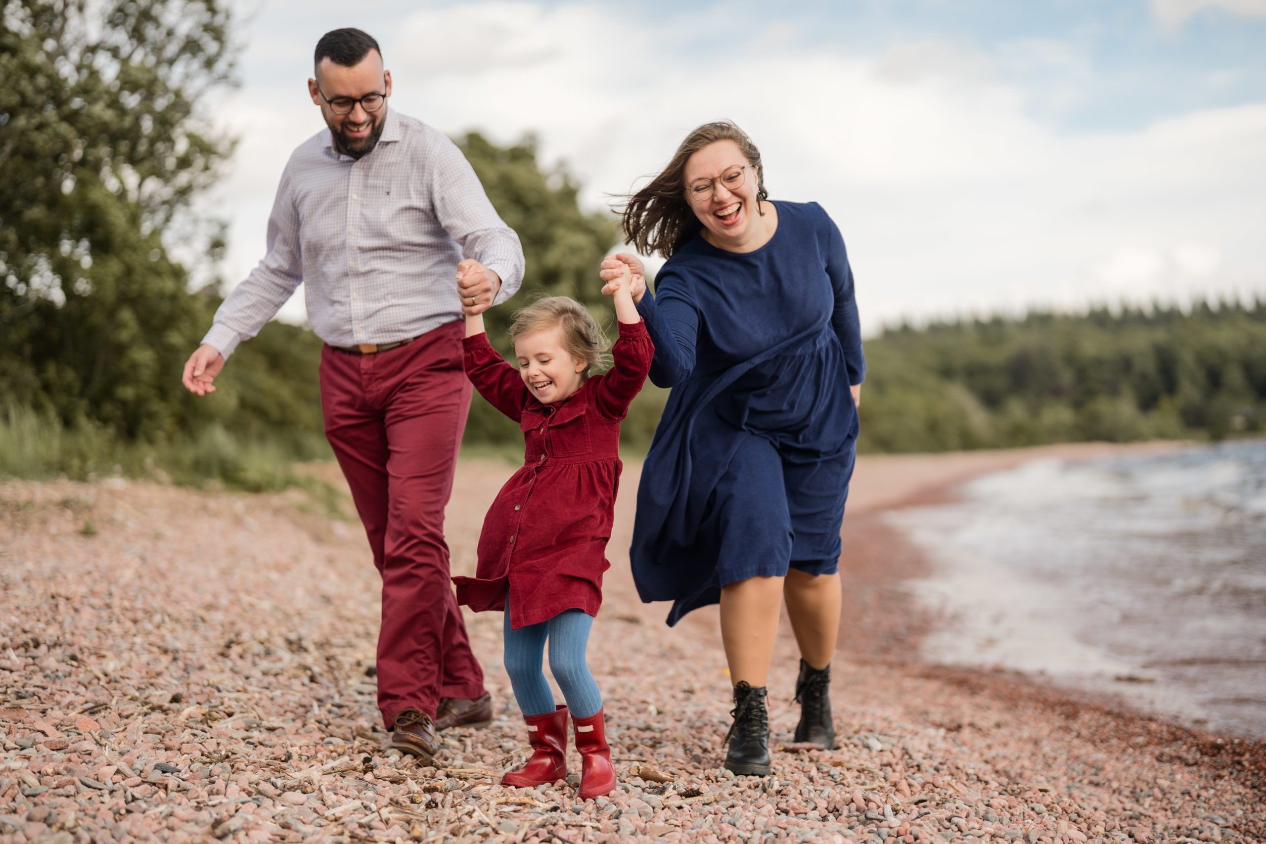 Parents and children strolling beside Loch Ness on a windy day