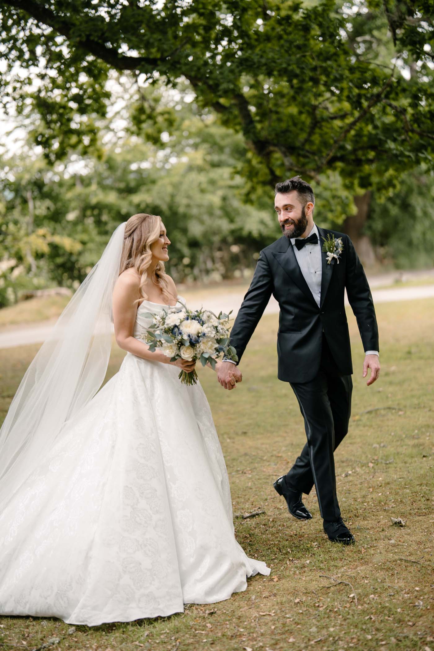 Bride and groom strolling through the woods