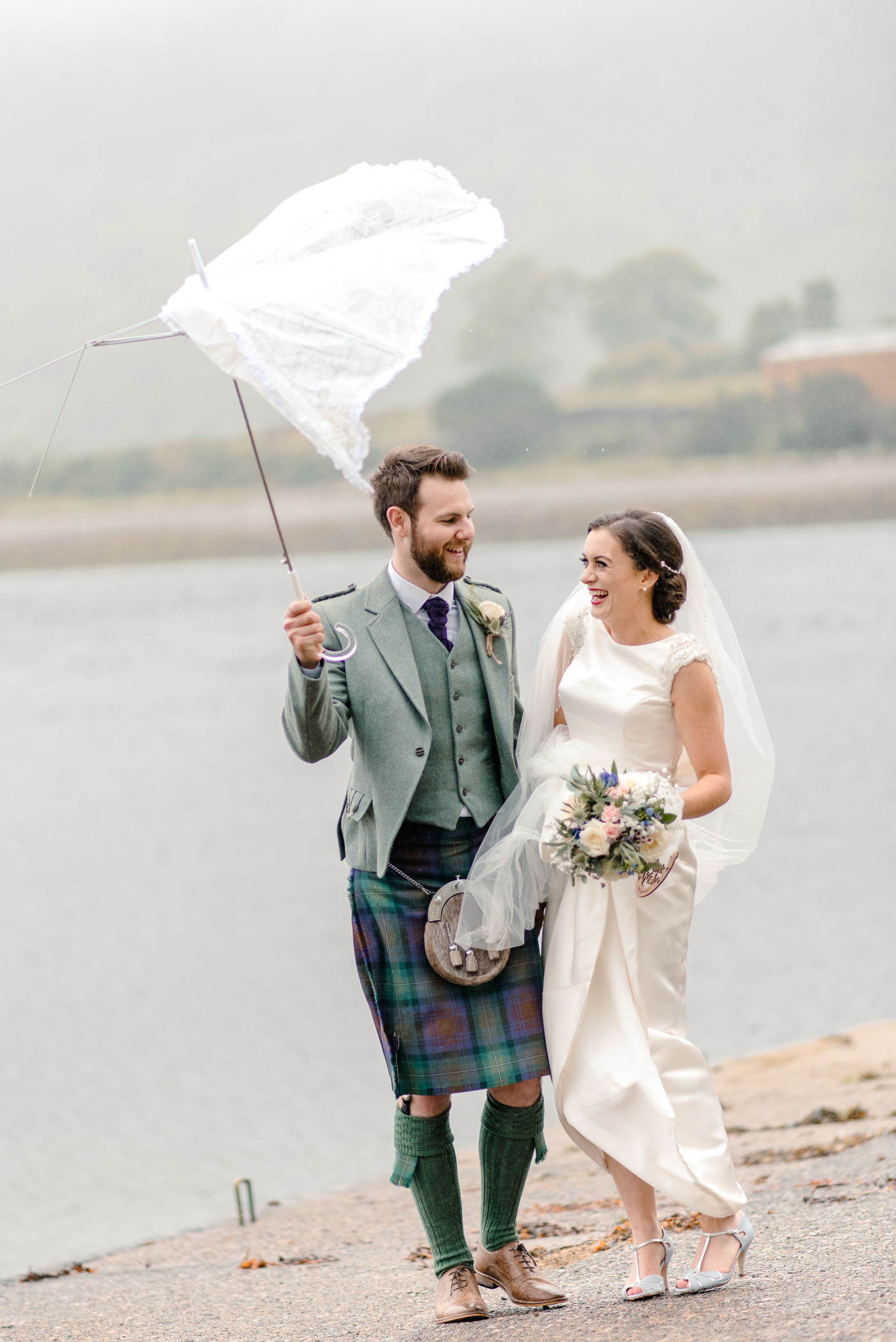Couple sharing a moment beneath a broken umbrella