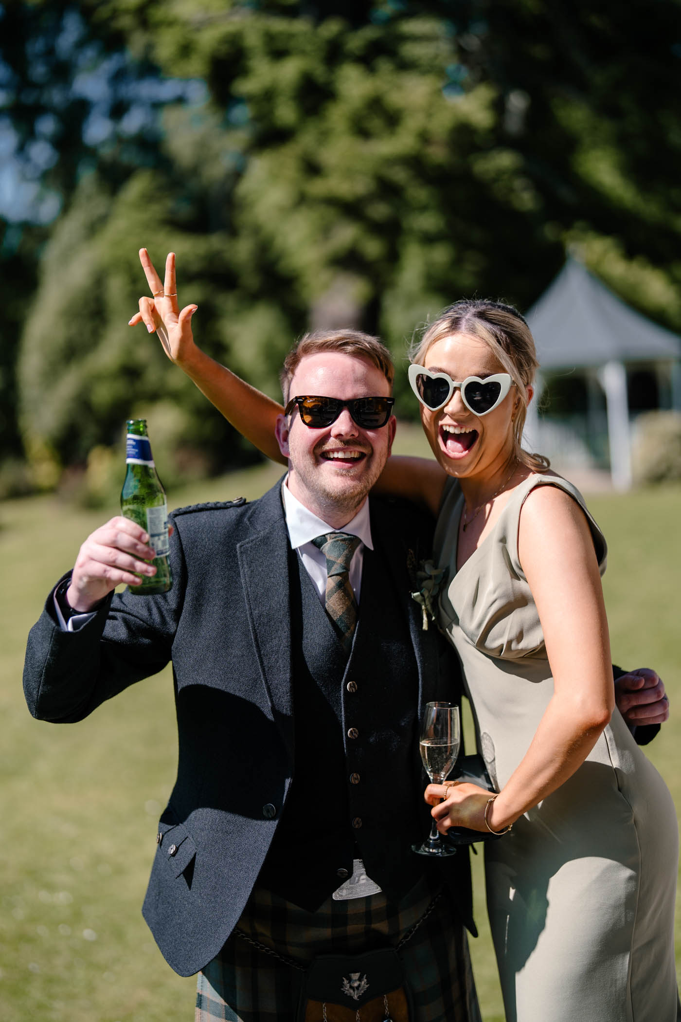 Guests enjoying themselves with sunglasses on at the wedding reception