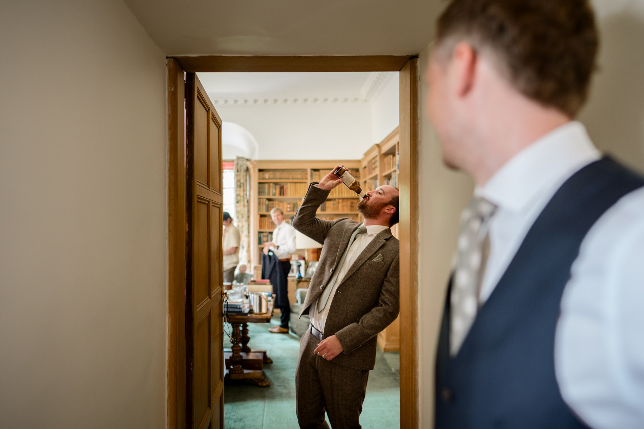 Groomens downing a beer