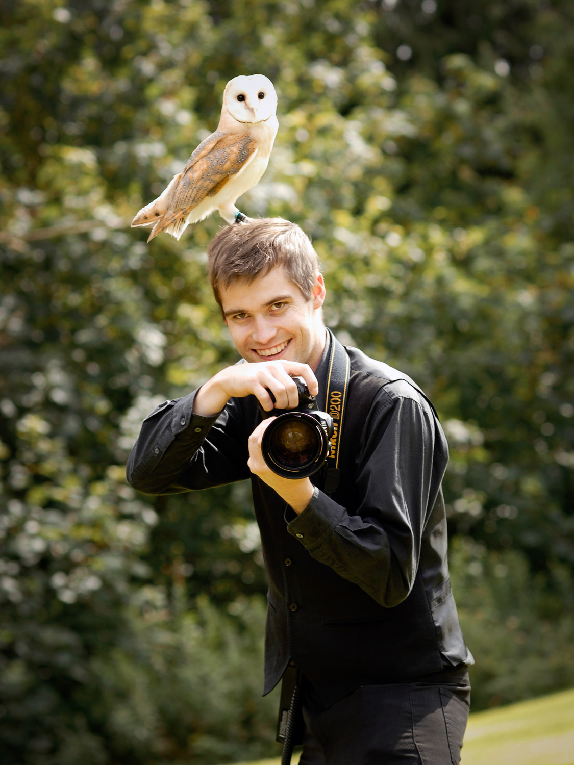 Andy Taylor, Photographer taking a photo with an owl on his head