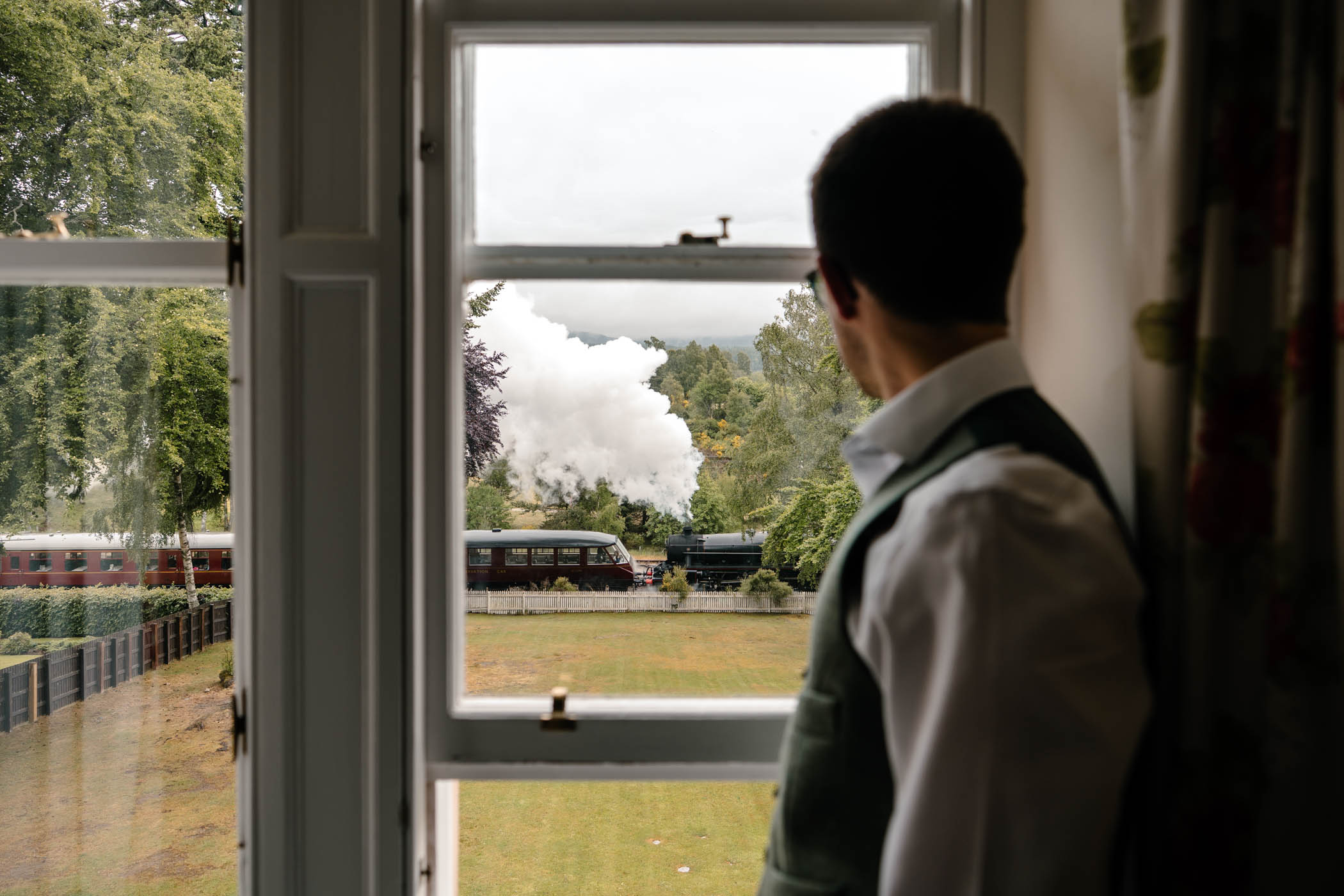 Groom observing a passing steam train