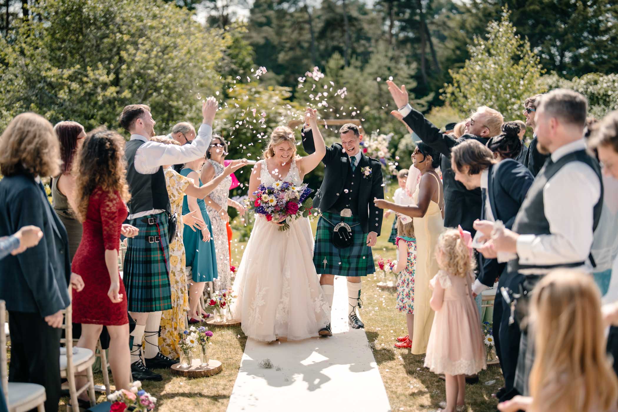 Newlyweds walking through a confetti shower