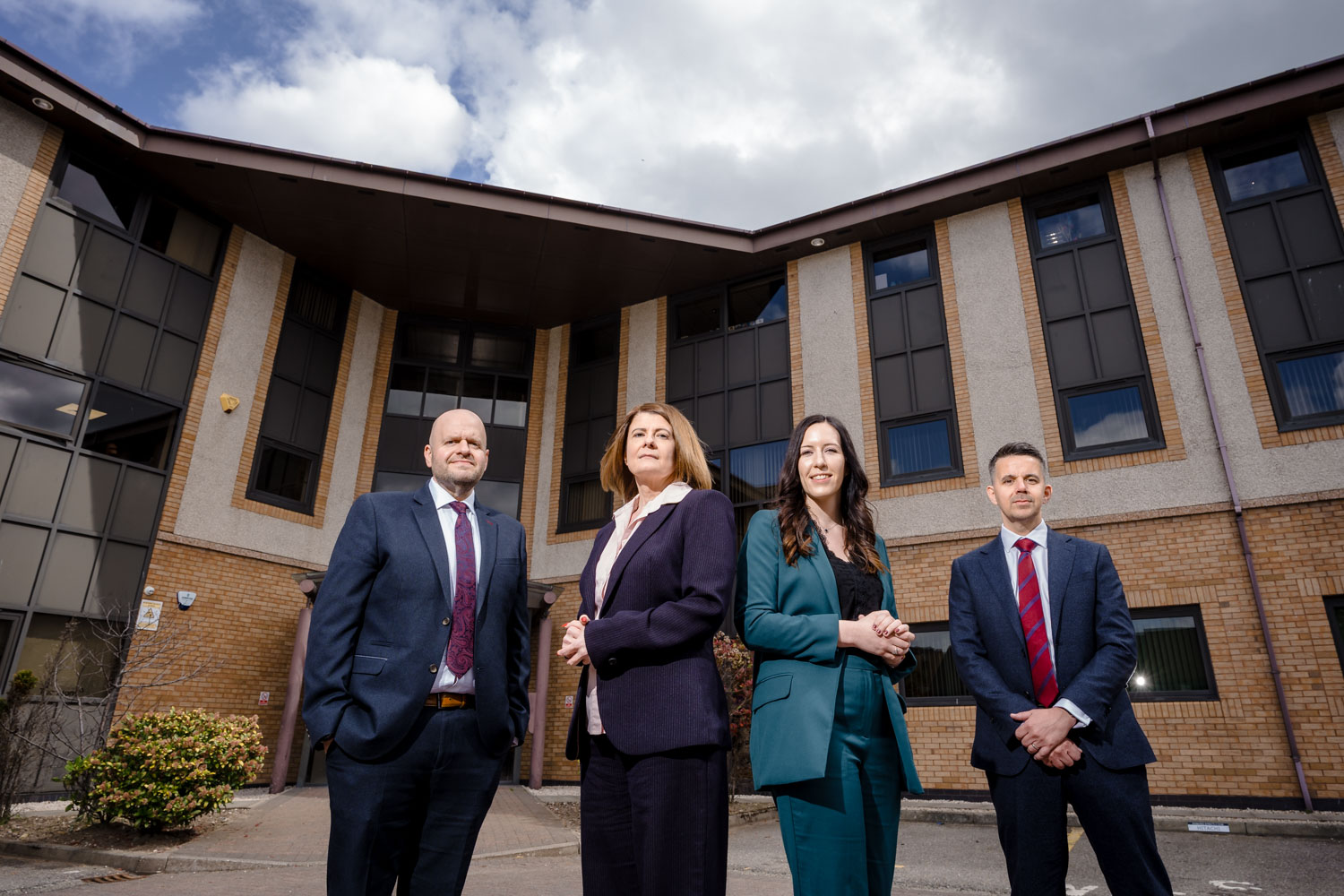 Small group of solicitors posing outside offices